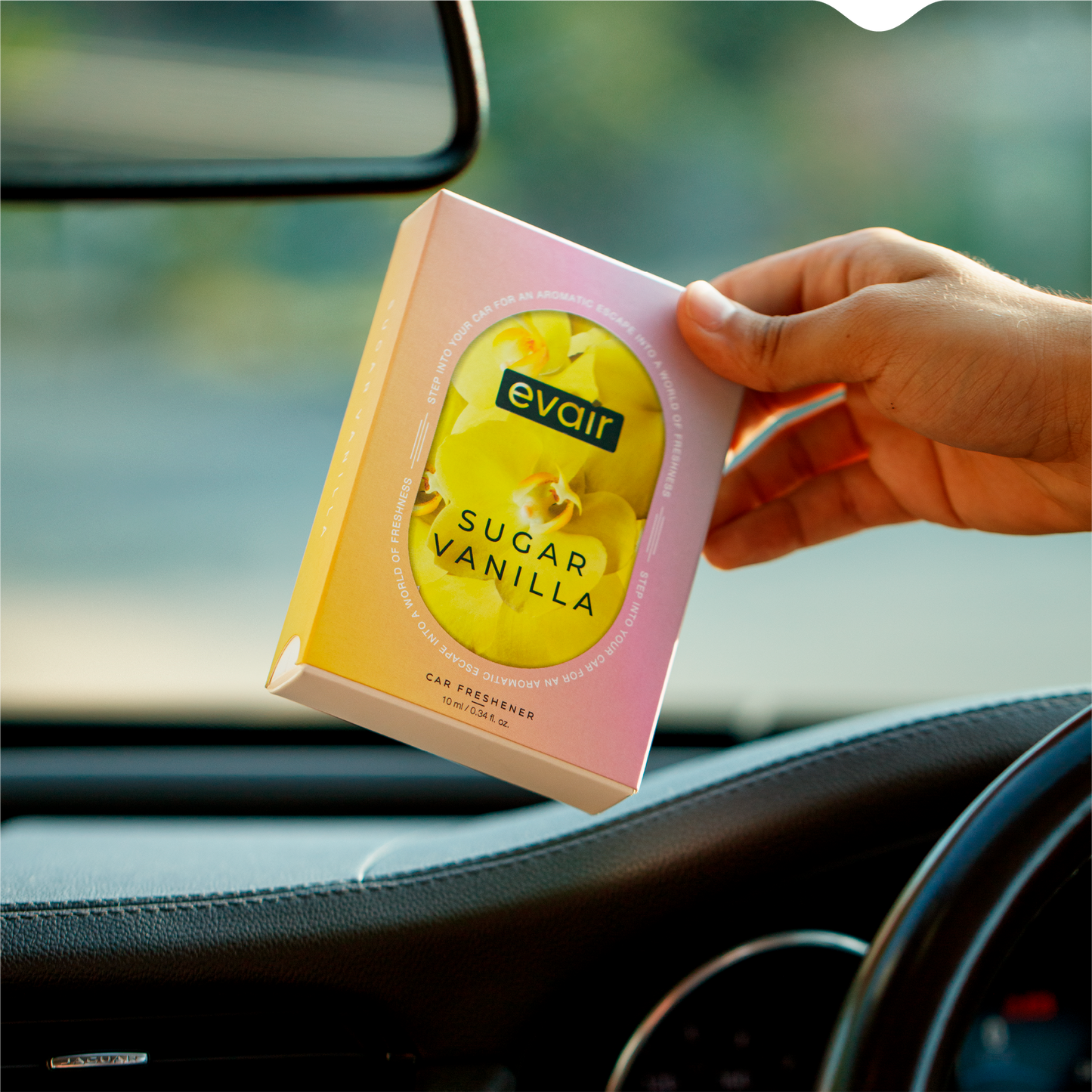 Men Holding Evair Vanilla Long lasting Car Perfume in car